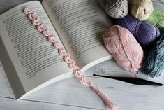 an open book with crochet and yarn on it