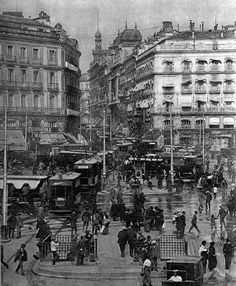 an old black and white photo of people in the street