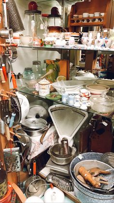 many pots and pans are stacked on top of each other in a kitchen area