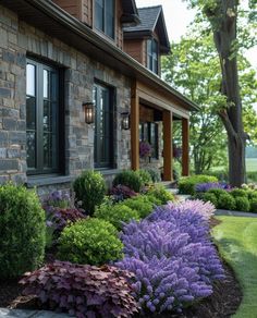 a house with lots of flowers in front of it