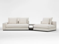 two white couches sitting next to each other on top of a white flooring