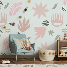 a child's room with pink and green wallpaper, a blue chair and toy animals on the floor