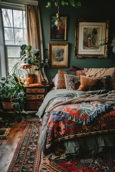 a bed sitting next to a window in a room with lots of pictures on the wall