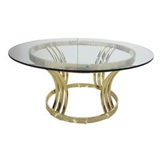 a round glass table with gold metal legs