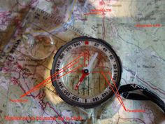 a compass on top of a map with red arrows pointing in different directions