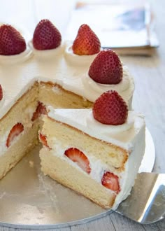 a cake with white frosting and strawberries on top