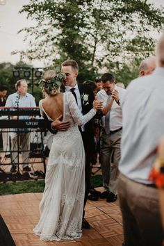 the bride and groom are dancing together on the dance floor at their wedding reception in an outdoor venue