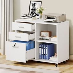 an office desk with drawers and printer on it, next to a window in a room