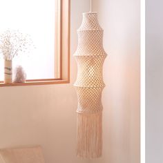 two pictures one is white and the other has a light fixture hanging from it's side