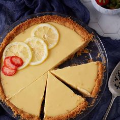 a pie with lemons and strawberries on top