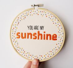 someone is holding up a cross - stitch hoop with the words you are my sunshine on it