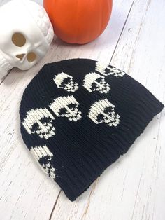 Black Skull Mens Beanie Cap Hand knitted Wool Cap with Skull  Unisex design, handmade  Perfect beanie for this Winter. Made with 100%  New Zealand  wool, lined with soft fleece.  Unique gift for your loved ones who are into gothic style.  Warm cap to wear every day or for hiking, running, skiing, or any outdoor activities.  Hand wash separately in cold water, flat dry. Stretches to fit into comfortable size. Approximate measurements:  Height-9" Width-10"  Black and Ivory color combination with s Black Novelty Beanie, Black Novelty Beanie One Size Fits Most, Novelty Black Beanie, One Size Fits Most, Black Skull Print Hat, Black Knitted Hat For Halloween, Black Skull Hat For Halloween, Skull Halloween Hat One Size Fits Most, Halloween Skull Hat One Size Fits Most, One Size Fits Most Skull Hat For Halloween