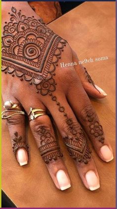 henna tattoo on the palm of a woman's hand