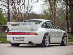 the rear end of a white porsche sports car