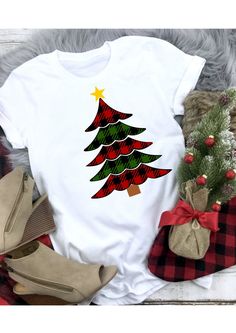 a white shirt with a christmas tree on the front and red plaid bows around it