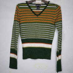 Wet Seal V-Neck Sweater Womens Jrs Small Green Orange Rib Knit Stripe Long Sleeve Banded Waist New With Tag 49% Acrylic, 21% Rayon, 30% Nylon 32" Bust, 20" Length Size Small By Wet Seal. Y2k V-neck Sweater For Fall, Retro V-neck Winter Tops, Retro V-neck Stretch Top, Green V-neck Y2k Tops, Y2k V-neck Fall Sweater, Y2k Style V-neck Sweater For Fall, Retro Green V-neck Sweater, Trendy Orange V-neck Sweater, Fitted Striped V-neck Sweater