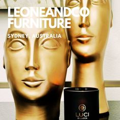 an advertisement for a furniture store with two mannequin heads and a candle in front of it