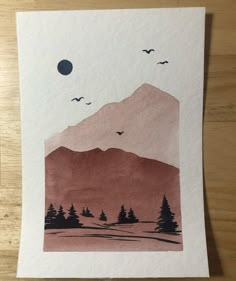 a piece of paper with trees and mountains on it