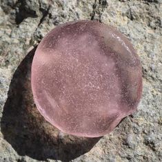 a rock with a pink substance on it