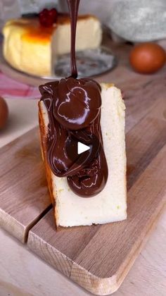 a piece of bread with melted chocolate on it sitting on top of a cutting board