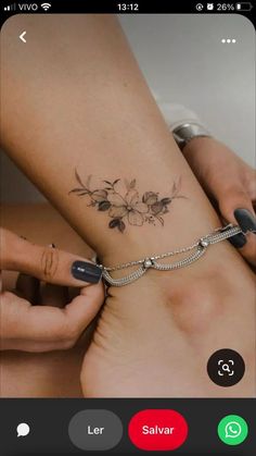 a woman's foot with a flower tattoo on the side of her leg and an arrow in the middle