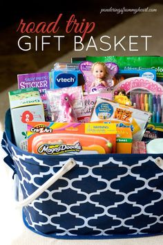 a blue and white basket filled with lots of different types of baby items on top of a table