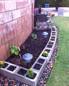 a garden bed made out of cinder blocks with plants growing in it and the words, 15 brilliant garden edging ideas