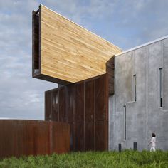 the building is made out of concrete and has wooden panels on it's sides