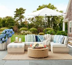 an outdoor living area with furniture and flowers