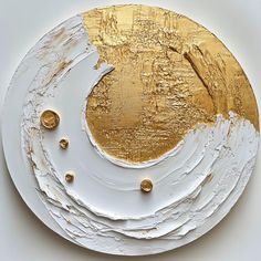 a white and gold painted plate with circles on the bottom, surrounded by small gold dots