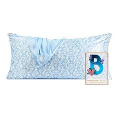 a blue and white pillow with the letter b on it next to an envelope bag