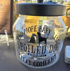 there is a glass jar that has a dog on it