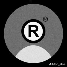 the letter r is inscribed in black and white on a round object with circles around it