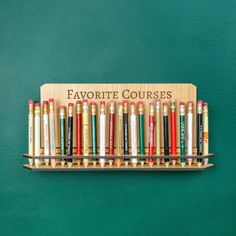 "This wall-mounted golf pencil holder is the perfect place to display golf pencils from all of your favorite courses! It comes with double-sided tape that will hold it securely to any surface. This display holds 23 pencils.  Want a desk version? Check out our desk golf pencil holder, which has room for 23 pencils: https://www.etsy.com/listing/1432319738/personalized-desk-golf-pencil-holder Also comes in a mini version: https://www.etsy.com/listing/1525399813/mini-desk-golf-pencil-holder-golf-pen Golf Outdoor Decor, Golf Scorecard Display, Golf Pencil Display, Golf Decorations, House Manifestation, Pencil Display, Thunder Laser, Barndo Ideas, Pencil Collection