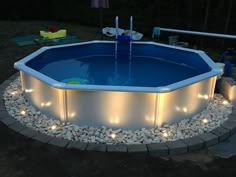 an above ground pool with lights around it