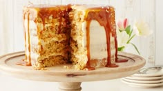 a cake with white frosting and caramel drizzled on the top