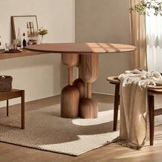 a wooden table sitting in the middle of a living room next to a chair and window