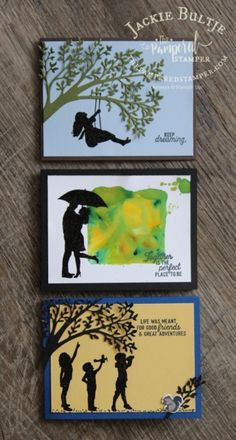 three cards with silhouettes of people holding umbrellas and one has a tree on it