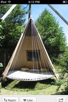 an image of a bed made out of a hammock hanging from a pole