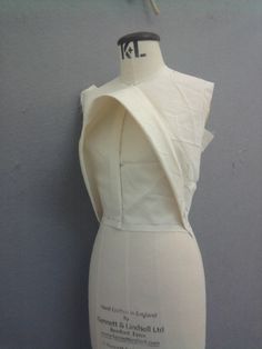 a mannequin with a white dress on it's back and neckline