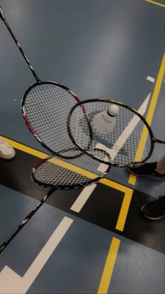 two tennis racquets laying on the ground