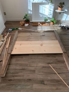 the floor is being prepared to be installed with wood and other items on top of it