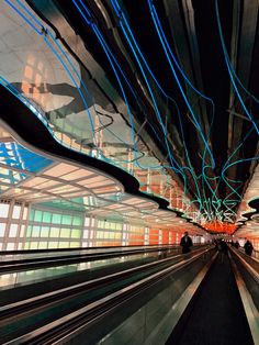 an abstract photo of the inside of a building with blue and green lines on it