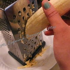 a person holding a banana over a grater