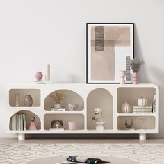 a living room with white walls and shelves filled with vases on top of them