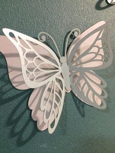 a paper cut butterfly hanging on the wall