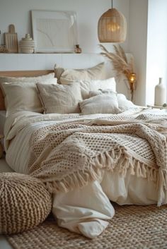 a bed with blankets and pillows in a room