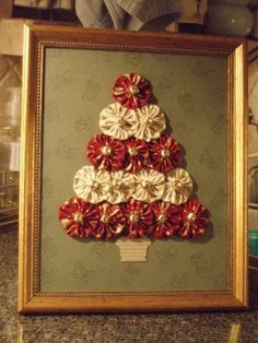 a christmas tree made out of flowers in a frame