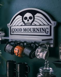 there is a sign that says good morning with coffee mugs and cups on the shelf