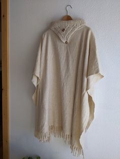 Amazing Wool poncho, cape, in woven cream wool with handknit collar detail. Real wood buttons are sewn on, but not functional. I believe that this was made by hand privately, not by a brand. Plenty of fabric to keep cozy, but with lovely drape and movement. While this is undoubtedly vintage, it also feels really relevant and versatile. The natural cream color looks amazing with denim and brown leather. Could look super chic belted! Sizing is very open, but I am happy to provide measurements for Traditional Beige Poncho For Winter, Beige Wool Poncho One Size, One Size Beige Wool Poncho, Handmade Beige Poncho One Size, Cozy Beige Wool Poncho, Beige Alpaca Poncho One Size, Beige Alpaca One-size Poncho, One Size Beige Alpaca Poncho, Wool Poncho